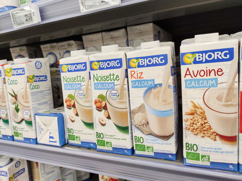 Organic milk packs of coconut, rice, oats and hazelnut on shelves in a supermarket by "Bjorg" Brand