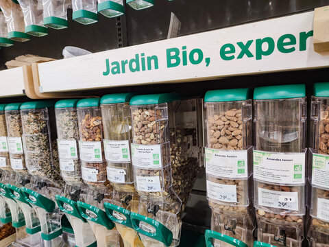 Closeup on Organic almond dispenser by "Jardin bio" brand in a French supermarket