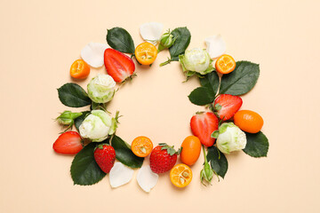 Roses, strawberry and kumquat on beige background, top view