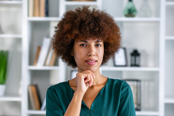 Fototapeta na wymiar Serious pensive African businesslady pose in company office staring at camera. Professional occupation person, millennial freelancer portrait, career growth, promotion concept