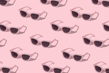 Pink sunglass on pink baclground. Creative pattern.