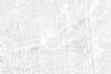 White water with ripples on the surface. Defocus blurred transparent white colored clear calm water surface texture with splashes and bubbles. Water waves with shining pattern texture background.