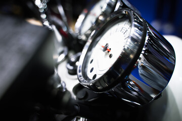 Side view of a black dial showing the speed of a vintage motorcycle