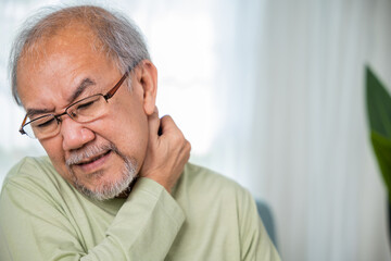 Close up of sad senior man neckache hand holding neck, old man suffering from nape neck pain at...