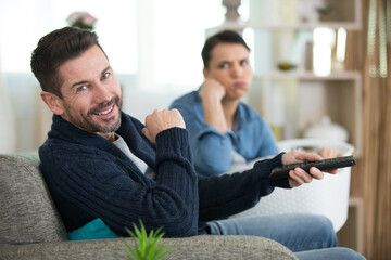 couple watching television in living room