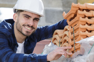 happy builder working on roof of new building