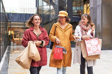 Empowered mature woman enjoying christmas shopping with friends in the city