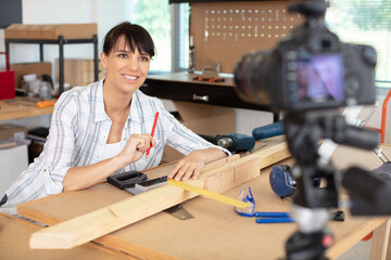 young woman in apron standing in front to camera