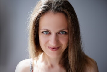 Naklejka premium Portrait of woman with light brown hair and blue eyes. Modern women concept
