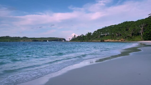 4k Video – Beautiful and remote Murrays Beach with calm waves, pristine clear waters and pearly white sand at sunset in Booderee National Park, Jervis Bay Territory, NSW, Australia. 