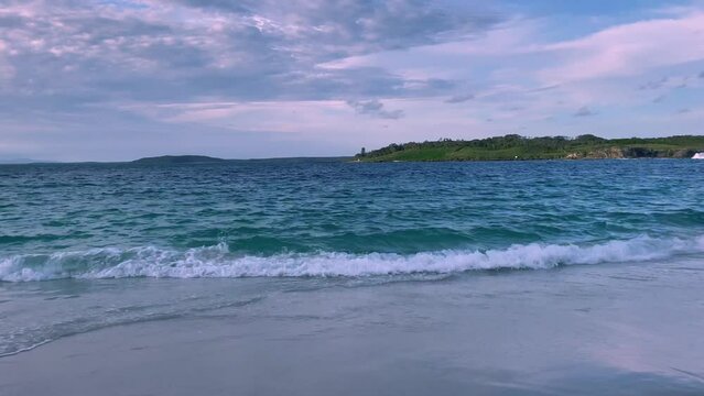 4k Video-Panning 180 degrees-beautiful and remote Murrays Beach with calm waves, pristine clear waters and pearly white sand at sunset in Booderee National Park, Jervis Bay Territory, NSW, Australia. 