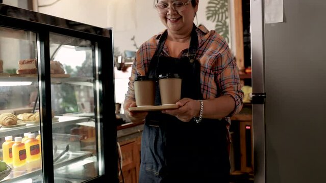 4K, Elderly aging society health care capability working, 60s retirement senior woman employed by small business cafe coffee owner female, Asian barista waitress women working together in bakery shop