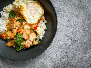 Rice topped with crispy pork belly with Thai basil and fried egg