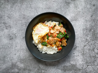 Rice topped with crispy pork belly with Thai basil and fried egg