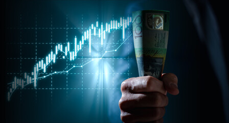 investment and finance concept, businessman holding virtual trading graph and blurred light on...