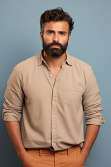 Obraz premium Portrait of a confident bearded male, with casual clothing, on a blue background