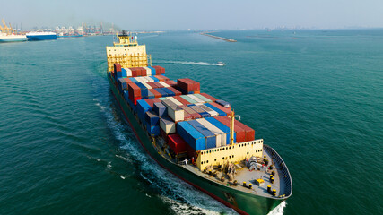 Fototapeta premium cargo logistic container ship sailing in sea to import export goods and distributing products to dealer and consumers worldwide, by container ship Transport, commercial port background,