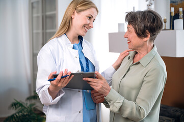 Smiling doctor showing good health test result to senior patient