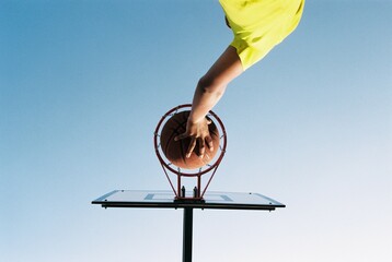 Basketball player scoring points through the hoop.