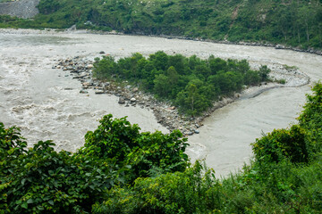 Isolated island in the Satluj River, surrounded by flowing waters, Himachal Pradesh, India