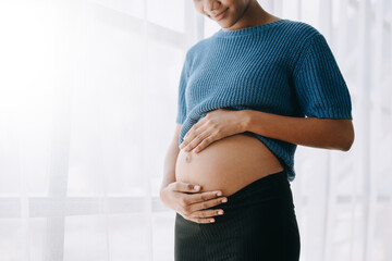 pregnant african american woman at home window white background. - obrazy, fototapety, plakaty