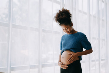 pregnant african american woman at home window white background.
