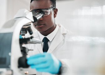 Microscope, black man and chemistry with research, medical and experiment with biotechnology....