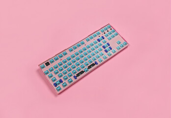 Pink mechanical keyboard without keycaps on the table