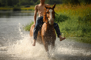 a horse with a rider galloping through the water during a cross-country race