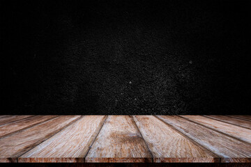 Wooden table or counter top with black stone wall background.