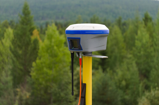 GNSS base station receiver running RTK mode at quiet and tranquil place among forest