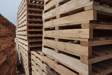 Wooden pallets. Stacking of wooden pallets. Concept of cargo transportation and shipping.Wooden pallets for transportation of building materials.