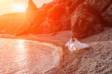 Mysterious woman silhouette long hair walks on the beach ocean water, sea nymph wind listens to the...