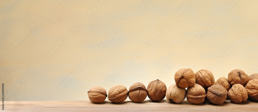 Poster Various walnuts including empty shells are set against a isolated pastel background Copy space