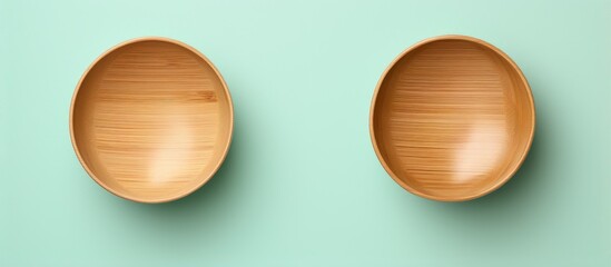 Two bamboo bowls on a isolated pastel background Copy space
