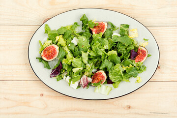 Tasty salad with figs, herbs and cheese.