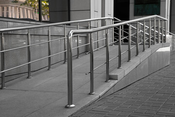 Ramp with metal handrails near building outdoors