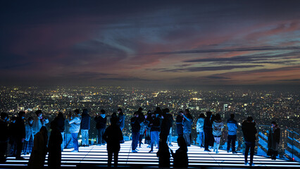 tokyo shibuya skydeck at dusk with people and lights