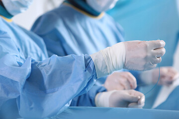 Surgeons' hands in close-up during surgery.Surgery on blood vessels. Endovascular surgery.