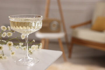 Glass of alcohol drink on table in room, space for text. Relax at home