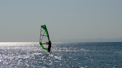 Recreational Water Sports. Windsurfing. Windsurfer Surfing The Wind On Waves In Ocean, Sea. Extreme Sport Action. Summer Fun Adventure.