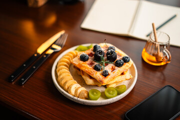 Waffles and mixed fruit on the desk