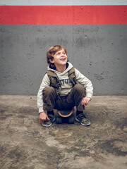 Excited kid sitting on street