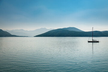 Picturesque view of the bay of Kotor with a yacht floating in the sea