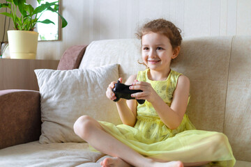 little girl playing VIDEO controller console station, holding gamepad joystick, playing game. child gaming. gadget addiction. kid gamer playing videogame at home © Елена Якимова