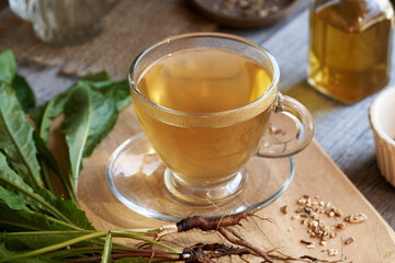 A glass cup of dandelion root tea on a table