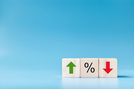 Wooden cube block with icon percentage symbol and arrow up and down direction