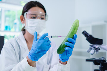 Close up of scientist use syringe to inject cucumber in biological laboratory. Concept of genetic modified organic vegetable food. Change and developing dna of plant. Innovation chemical biotechnology