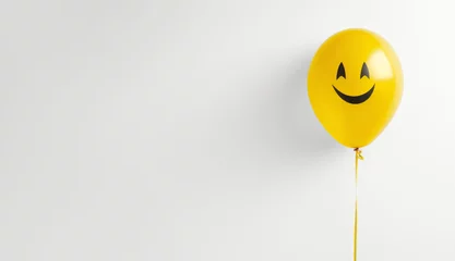 Foto op Canvas Yellow balloon with a smiley face on white background, copy space © happy_finch