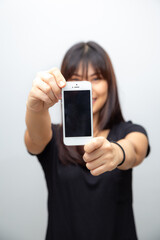 Beautiful asian woman show empty screen of smartphone on white background